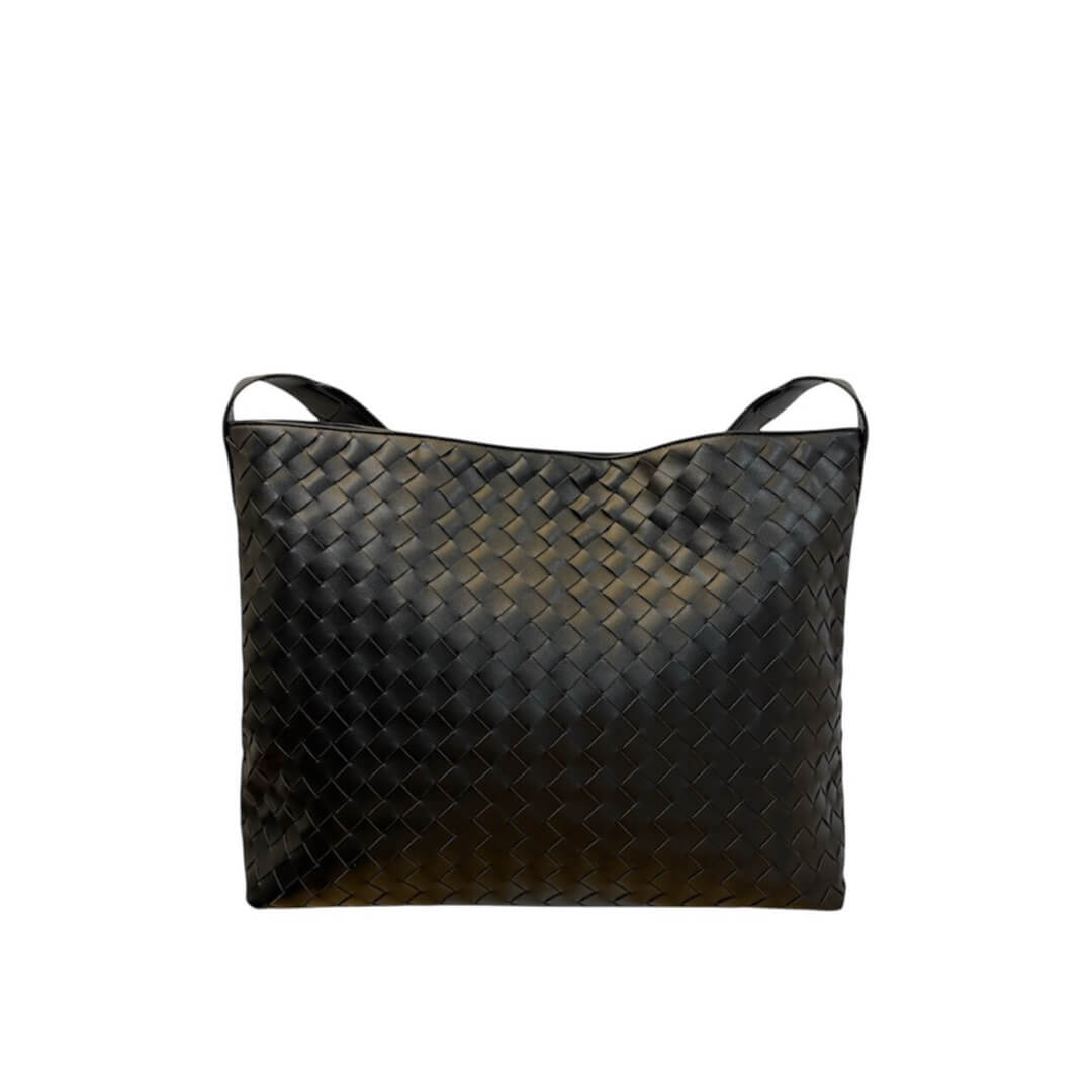 Black woven handbag on a white background