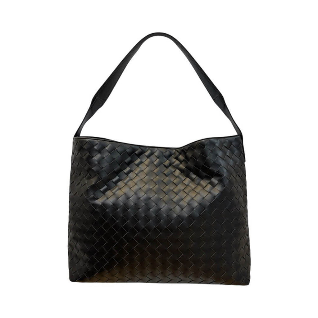 Black woven handbag on a white background