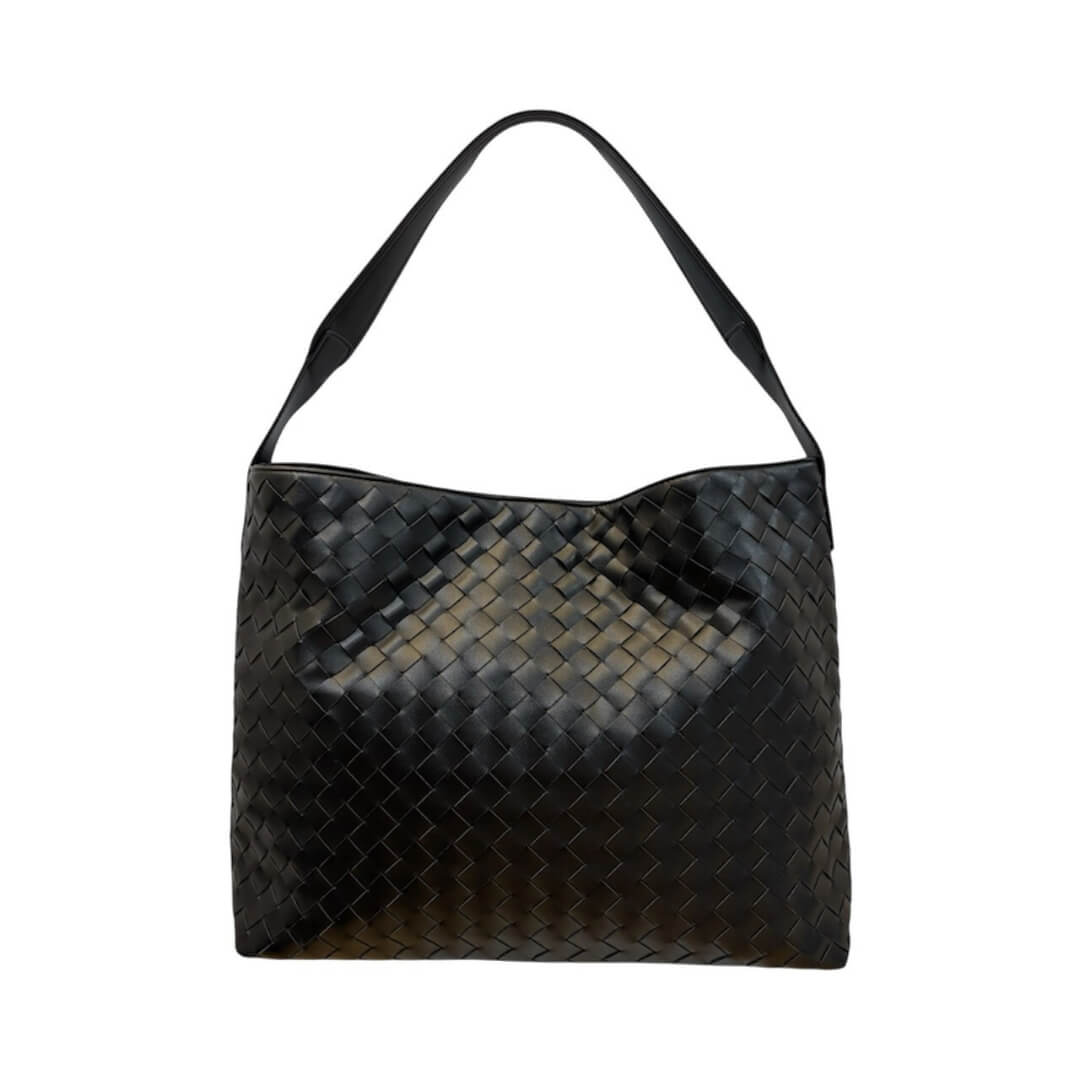 Black woven handbag on a white background