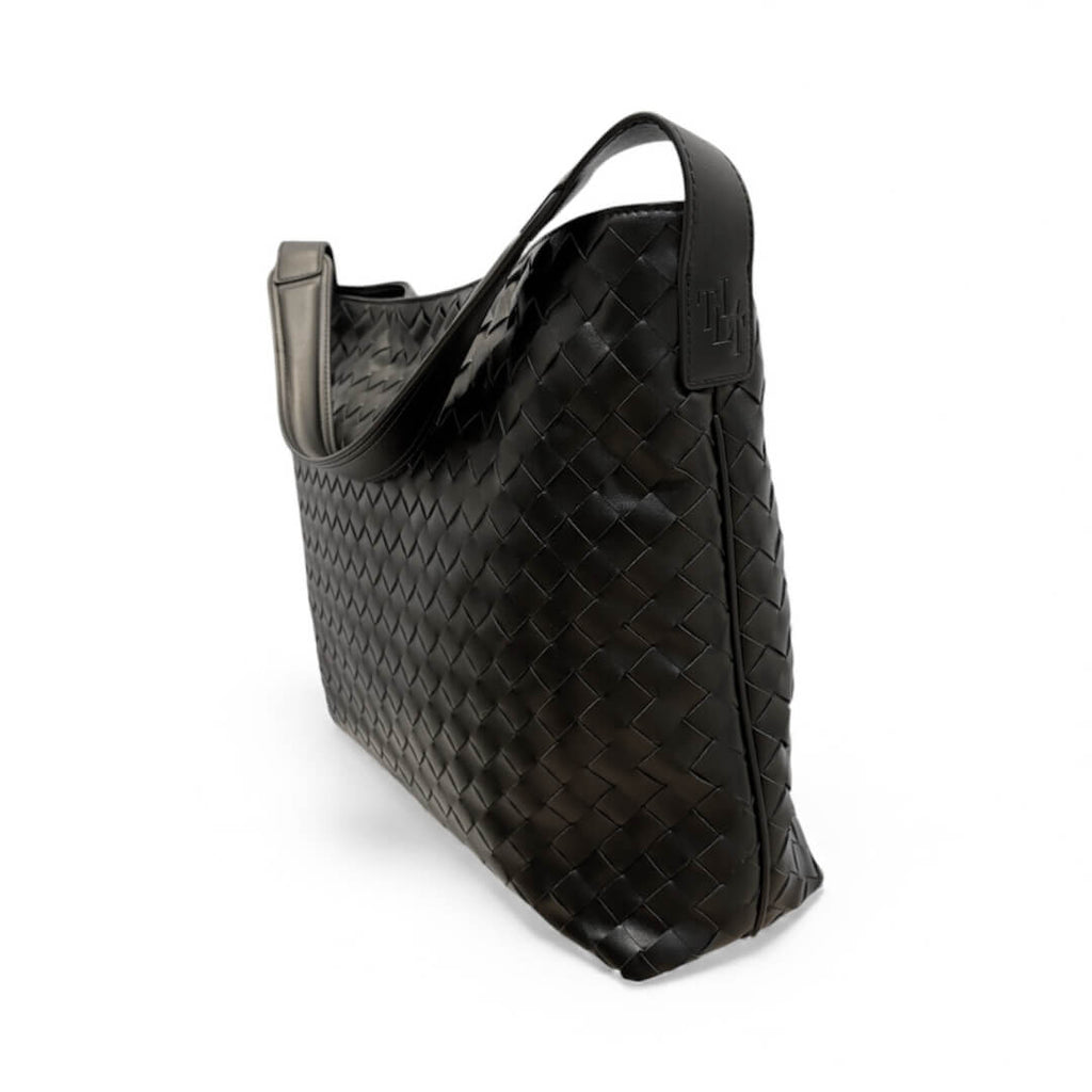 Black woven handbag on a white background