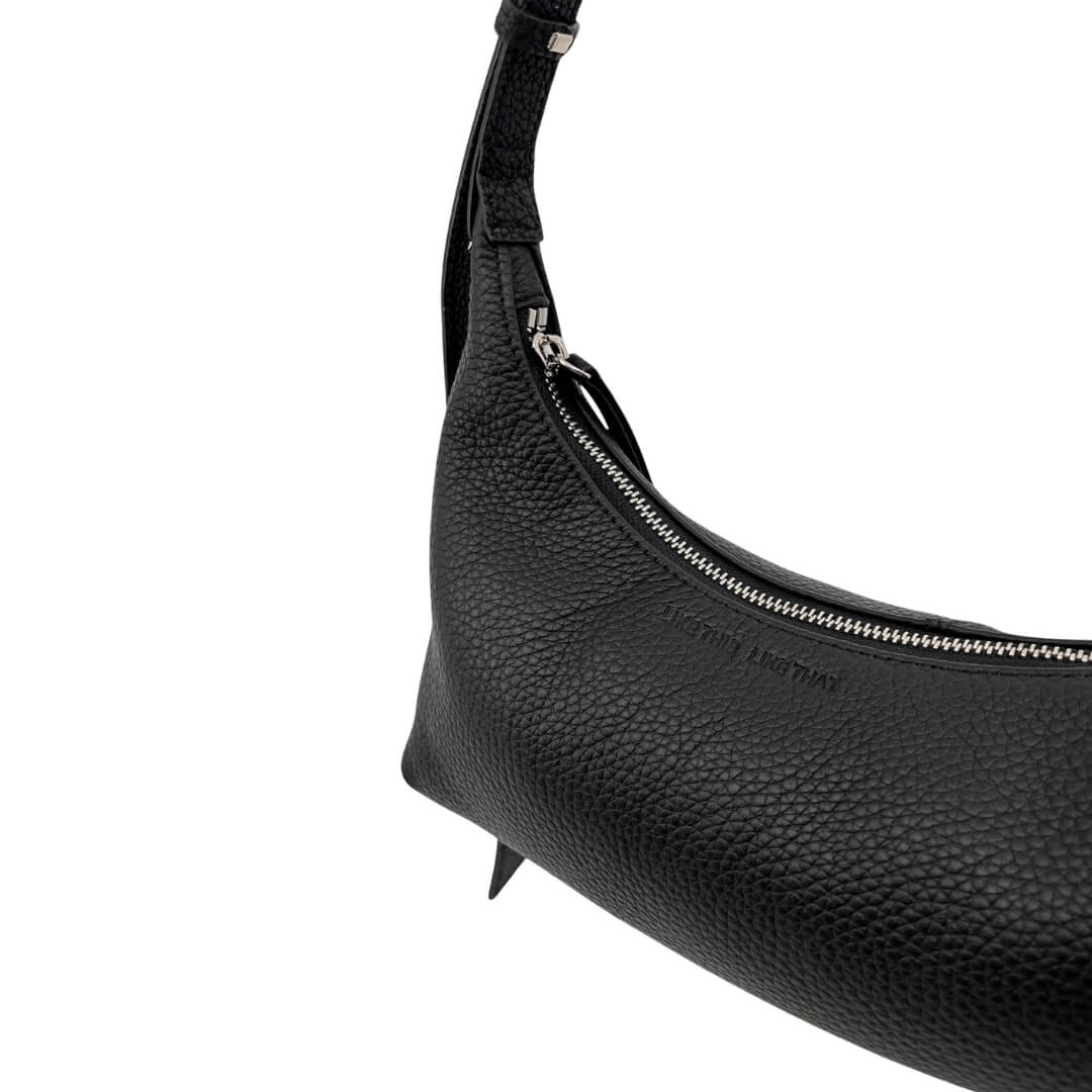 Black leather handbag with a zipper on a white background