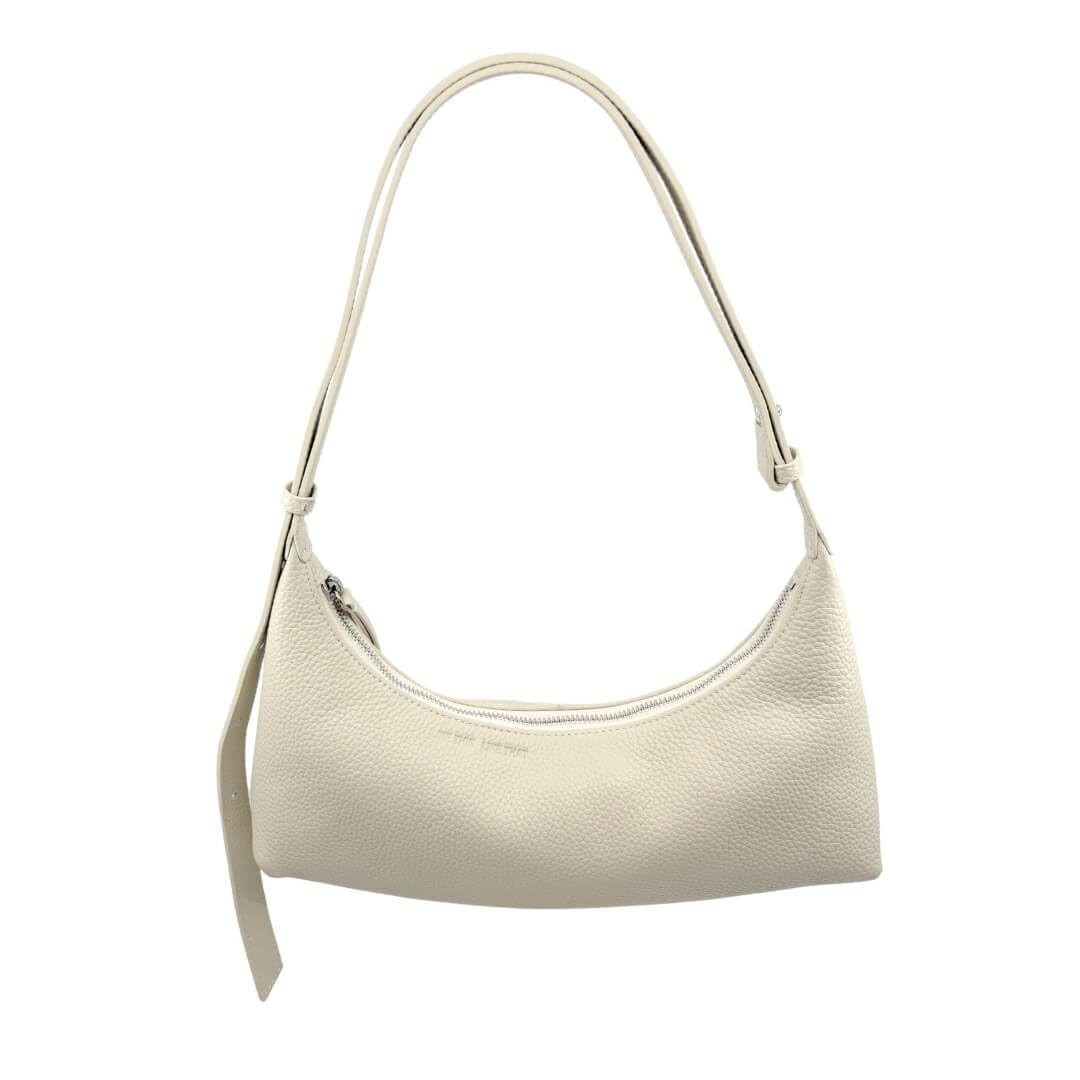 Ivory Ash handbag with a strap on a white background