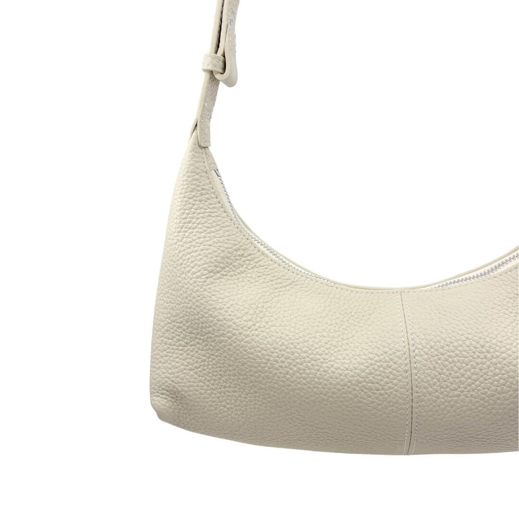 Ivory Ash handbag with a strap on a white background